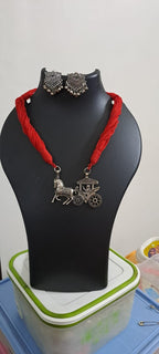 Red thread necklace with silver oxidised traditional pendant