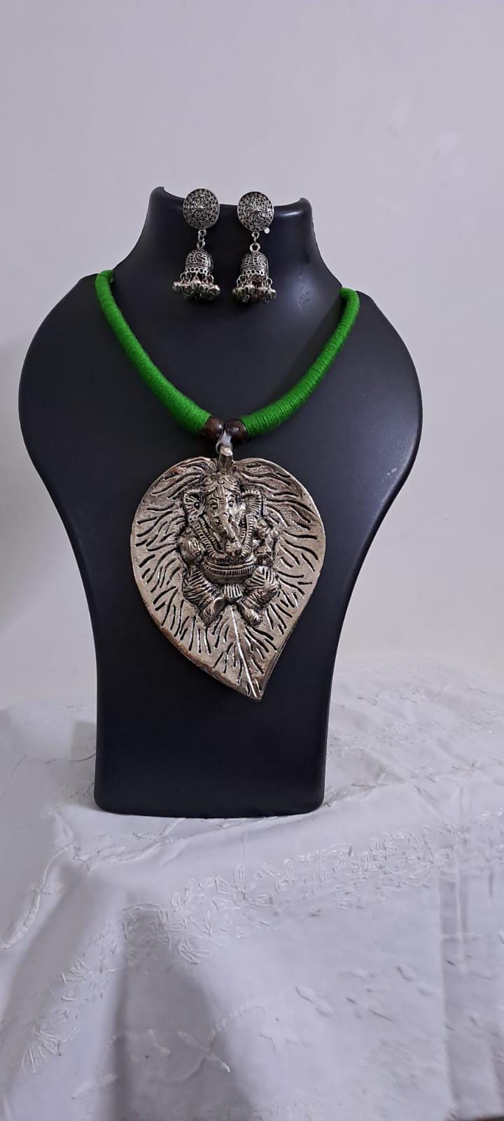 Green thread necklace with silver oxidised ganesha pendant