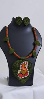 Exclusive forest green and brown thread necklace with leaf shaped  Ganesha thread pendant and matching earrings.