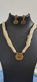 Off white thread necklace with oxidised silver sunflower pendant