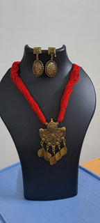 Red thread necklace with golden oxidised traditional pendant