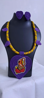 Exclusive yellow and purple thread necklace with leaf shaped  Ganesha thread pendant and matching earrings.