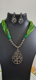 Green thread necklace with silver oxidised traditional pendant