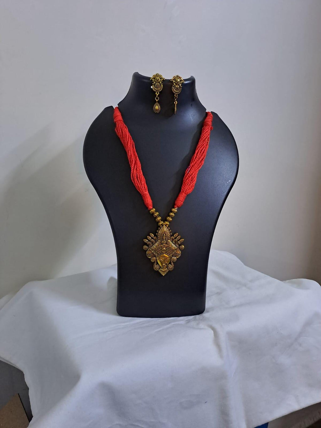 Red thread jewellery set with golden durga pendant n matching earrings