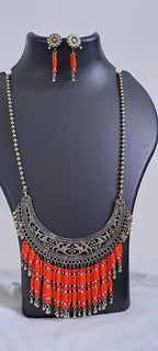 Exclusive necklace with silver oxidised big oval pendant with glass beads fringes and matching earrings.