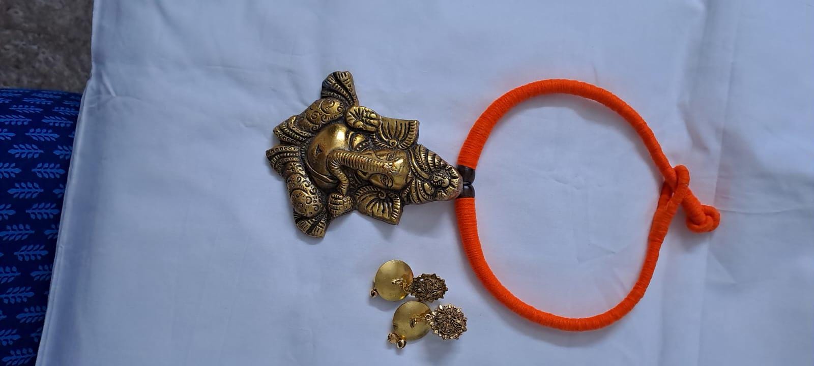 Orange thread necklace with golden oxidised ganesha pendant
