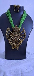 Green thread necklace with oxidised golden durga pendant