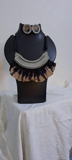 Exclusive necklace with silver oxidised big oval pendant with fabric fringes and matching earrings.