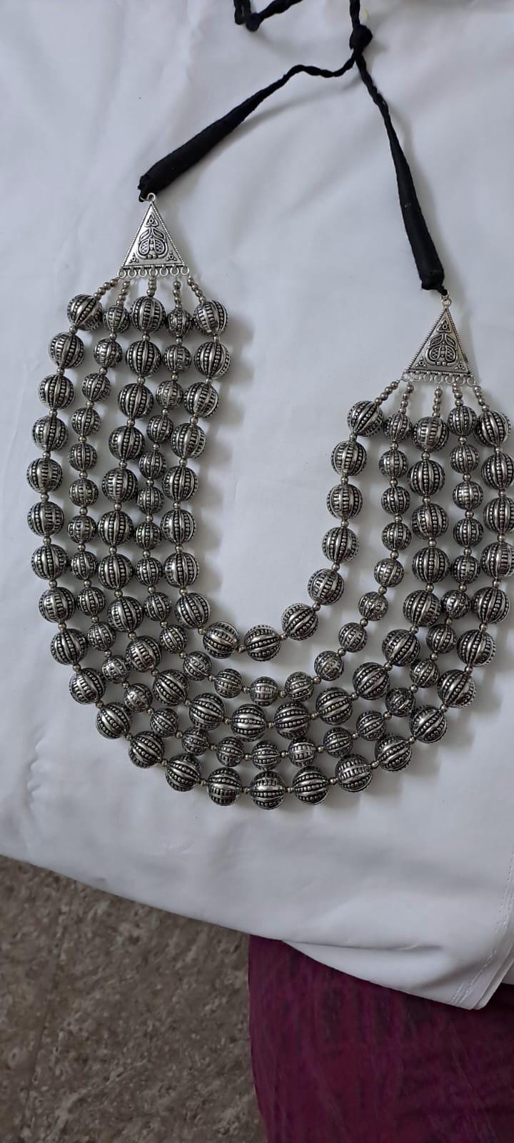 Multi-layered silver oxidised beads necklace .