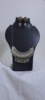 Exclusive necklace with silver oxidised big oval pendant with beads fringes and matching earrings.