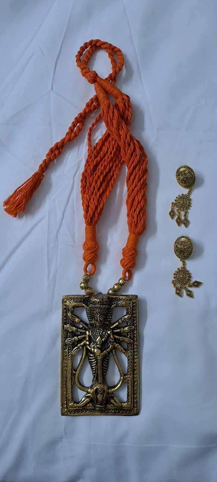 Orange thread necklace with oxidised golden durga pendant