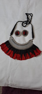 Exclusive necklace with silver oxidised big oval pendant with fabric fringes and matching earrings.