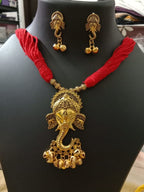 Oxidised golden ganesha traditional pendant and matching earrings.