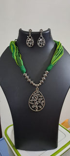 Green thread necklace with silver oxidised traditional pendant
