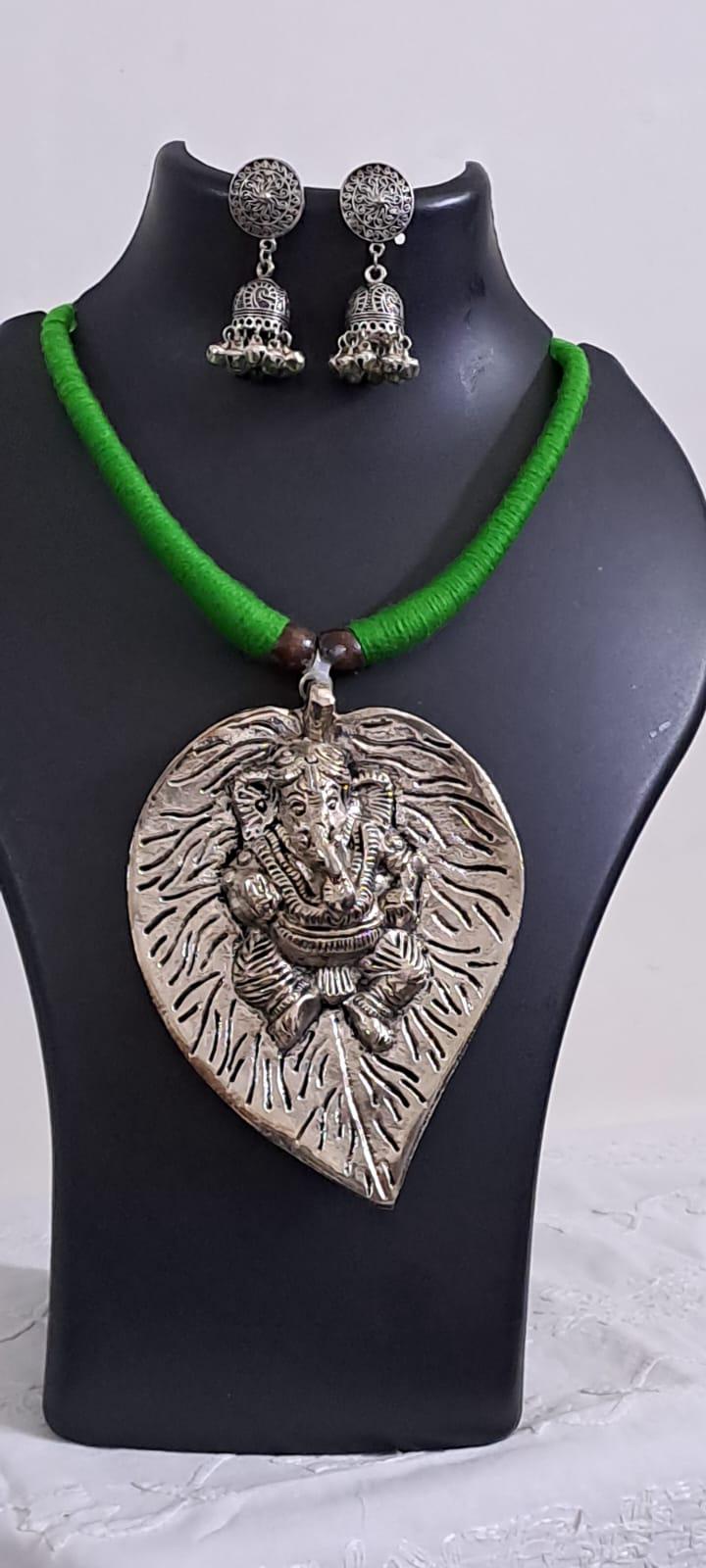 Green thread necklace with silver oxidised ganesha pendant