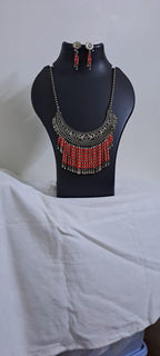 Exclusive necklace with silver oxidised big oval pendant with glass beads fringes and matching earrings.