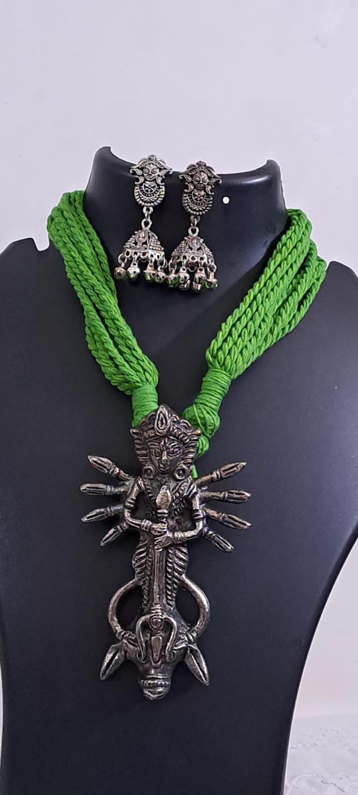 Green thread necklace with oxidised silver durga pendant