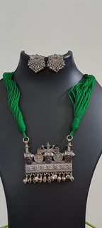 Green thread necklace with silver oxidised traditional pendant
