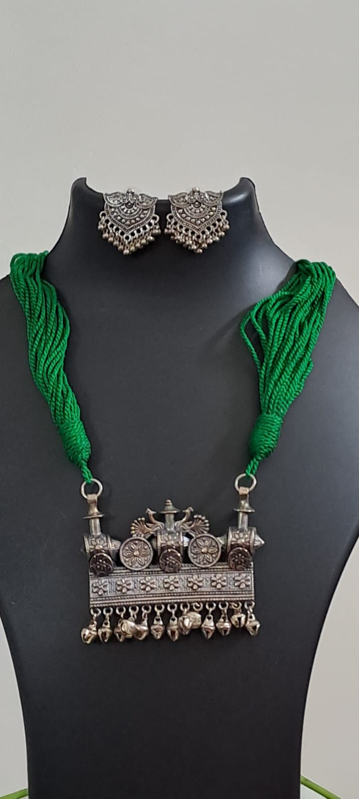 Green thread necklace with silver oxidised traditional pendant
