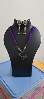 Purple thread necklace with oxidised silver durga pendant
