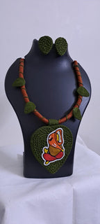 Exclusive forest green and brown thread necklace with leaf shaped  Ganesha thread pendant and matching earrings.