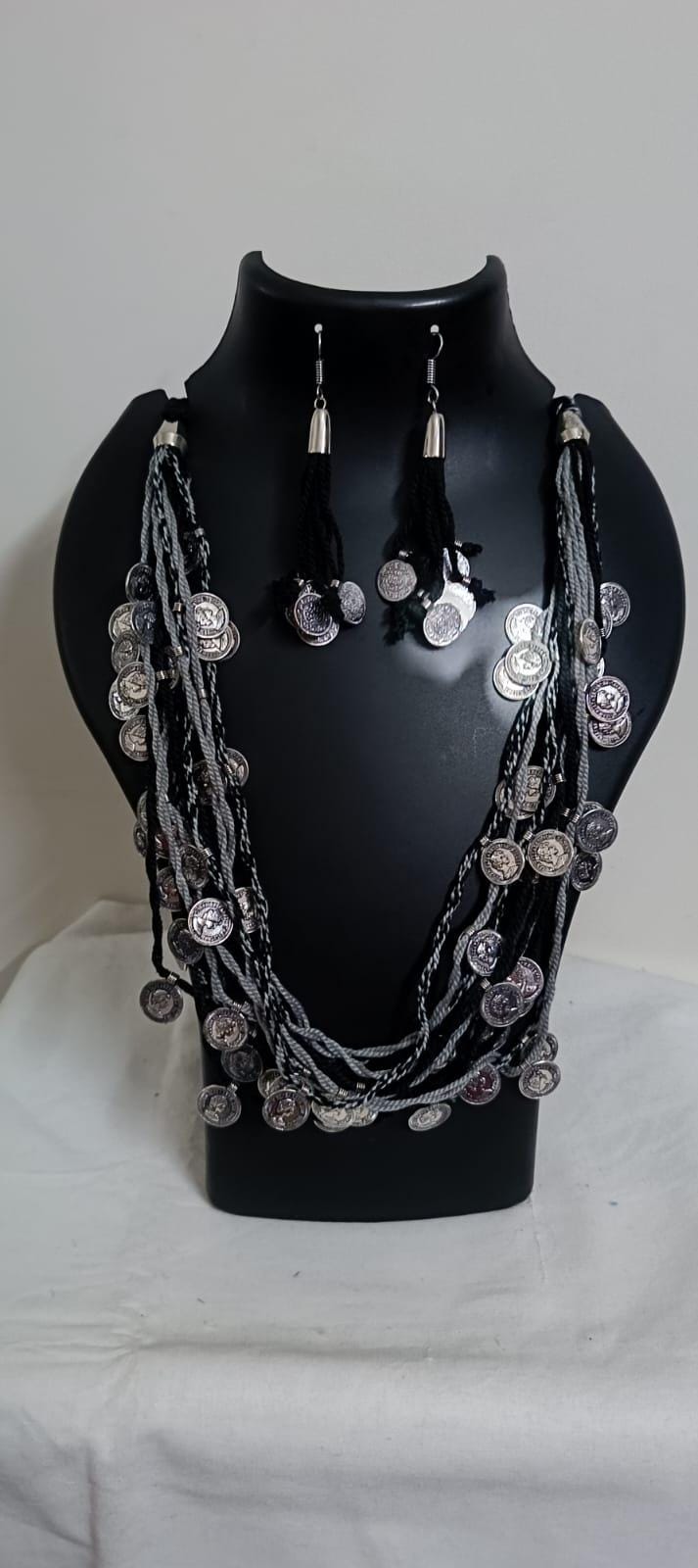 Exclusive multi-coloured and multi-layered thread necklace with silver oxidised charms
